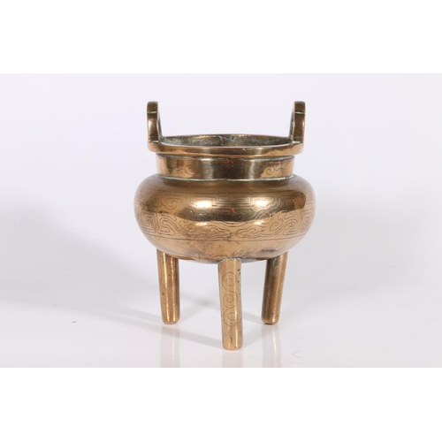 421 - 19th century bronze censer of ding form with upright loop handles, the body incised with key fret, a... 