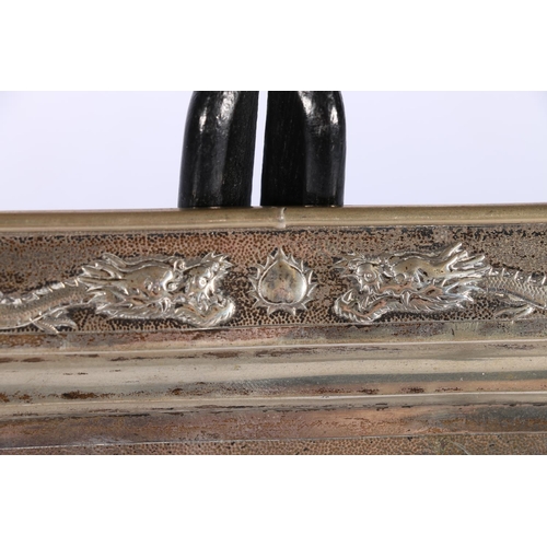 438 - Chinese silver card tray of rectangular shape, on four ball feet, decorated with dragons on a punche... 