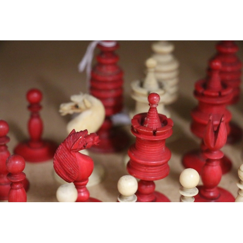 445 - 19th century English turned ivory and red stained ivory chess set, the king 10.5cm, complete 32 piec... 