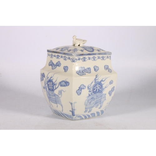 452 - Oriental blue and white jar and cover of rounded square section, decorated with mythical creatures a... 