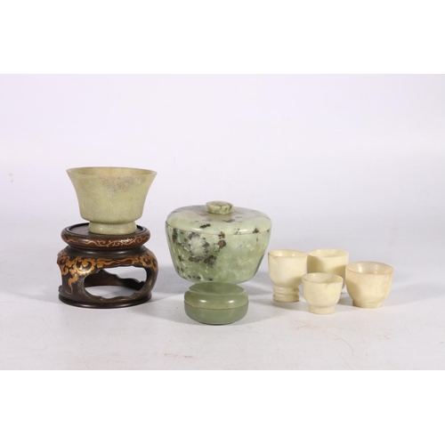 454 - Jade and hardstone cups, jars and covers, and small bowls to include a green jade cup with flaring r... 