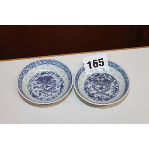 165 - Pair of Chinese dragon decorated blue and white rice bowls.