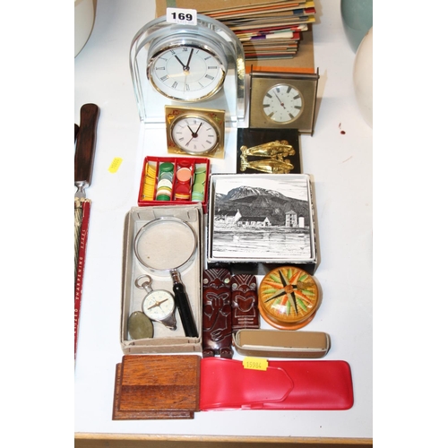 169 - Mantel clocks, two New Zealand carved figures, counters, etc.