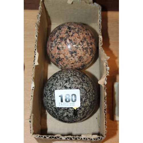 180 - Two hardstone bowling balls.