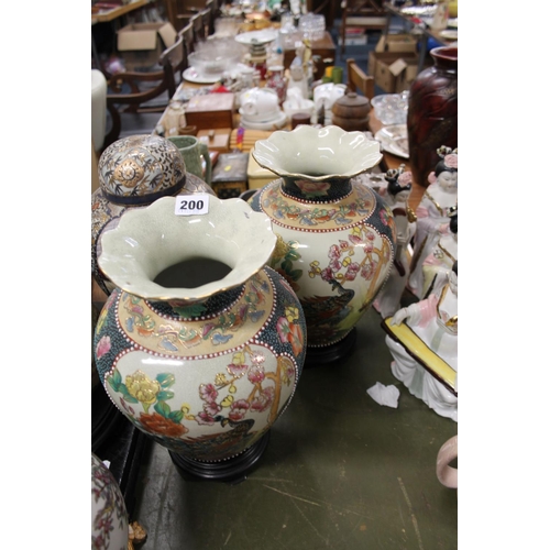 200 - Pair of oriental floral decorated vases on stands.