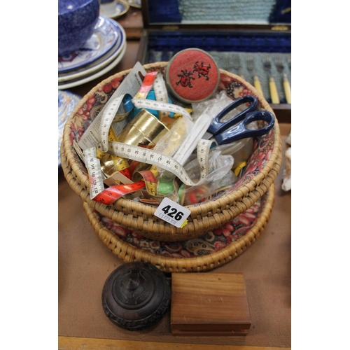 426 - Basket containing haberdashery, a carved wood pot and cover, etc.