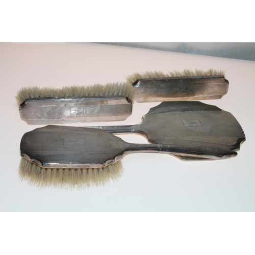 452 - Silver backed four-piece vanity set.