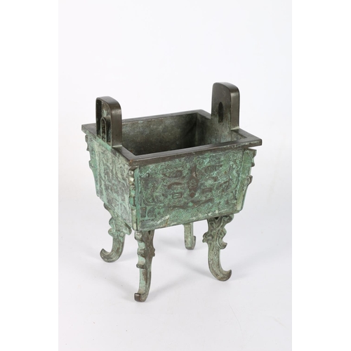 440A - A Chinese bronze fangding shaped vessel with archaic decoration, stylised face decoration ona key fr... 