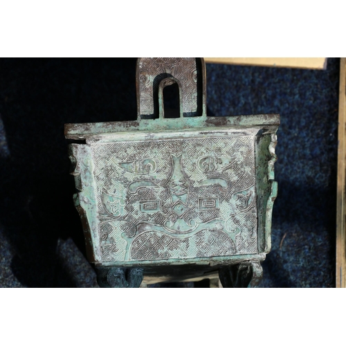 440A - A Chinese bronze fangding shaped vessel with archaic decoration, stylised face decoration ona key fr... 