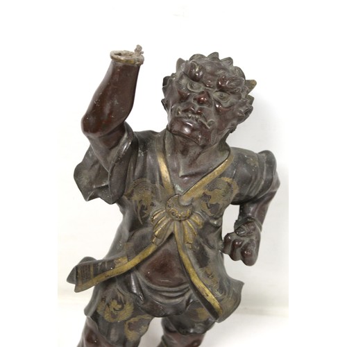 262 - Japanese Meiji Period lacquered bronze figure of an Oni standing with raised arm and clenched fist, ... 