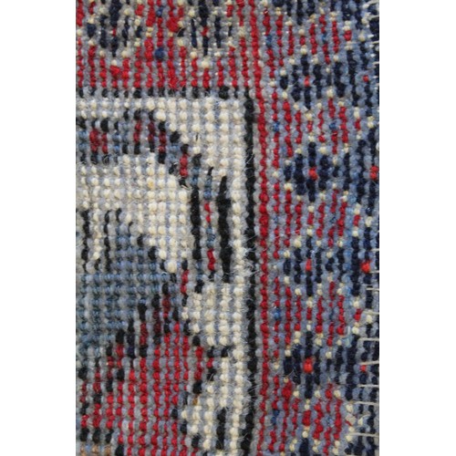 88 - 20th century Caucasian carpet in predominantly blue, red and white wools on cotton, with two geometr... 