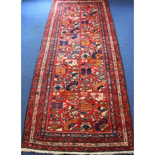 87 - Modern Caucasian Karabakh carpet or runner in wool on cotton, in reds and blues with stylised flower... 