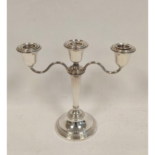 48 - Two branch three light candelabra of neo classical form, with finial, on tapering stem on circular b... 