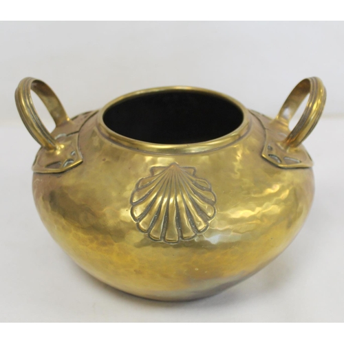 320 - Arts & Crafts brass pot of circular twin handled form with hammered ground and repousse scallop ... 