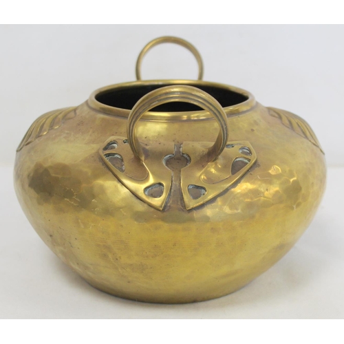 320 - Arts & Crafts brass pot of circular twin handled form with hammered ground and repousse scallop ... 