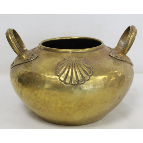 320 - Arts & Crafts brass pot of circular twin handled form with hammered ground and repousse scallop ... 