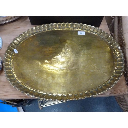 86 - Three brass trays including Indian-style tray, lamp, metal and wood-handled flat iron etc.