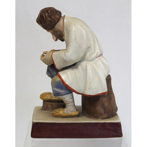 524 - Russian Moscow/Gardner bisque porcelain figure of a seated man braiding lapti (bast shoes). Painted ... 