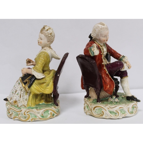 525 - Pair of 19th century porcelain figures of a seated boy reading a book and girl tatting, in 18th cent... 