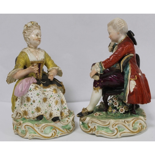 525 - Pair of 19th century porcelain figures of a seated boy reading a book and girl tatting, in 18th cent... 