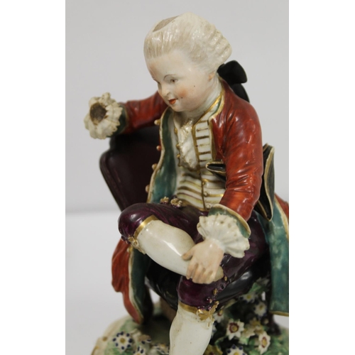 525 - Pair of 19th century porcelain figures of a seated boy reading a book and girl tatting, in 18th cent... 