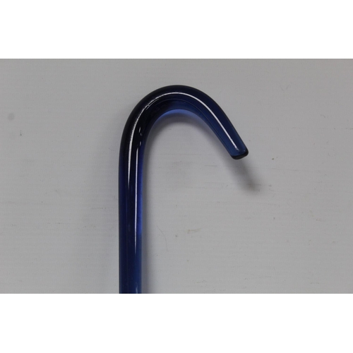 527 - Victorian blue glass walking stick of plain form with curved handle, 96cm long.