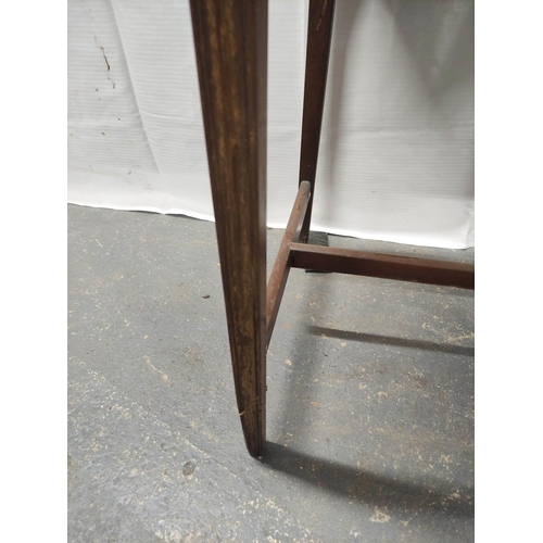 531 - Mahogany bijouterie table with a glazed hinged top on tapered supports with understretcher. 69cm hig... 