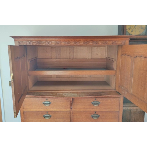 560 - Attributed to Arthur Simpson of Kendal. Arts & Crafts oak side cupboard with plain pediment and ... 