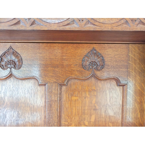 560 - Attributed to Arthur Simpson of Kendal. Arts & Crafts oak side cupboard with plain pediment and ... 