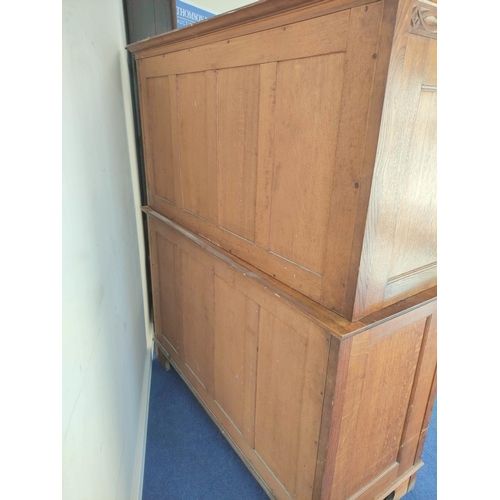 560 - Attributed to Arthur Simpson of Kendal. Arts & Crafts oak side cupboard with plain pediment and ... 