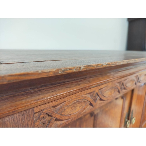 560 - Attributed to Arthur Simpson of Kendal. Arts & Crafts oak side cupboard with plain pediment and ... 