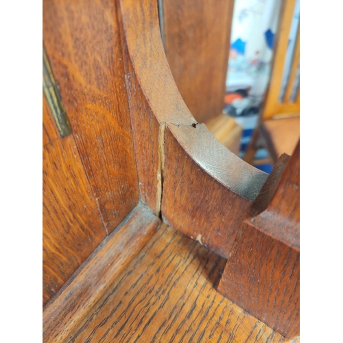 560 - Attributed to Arthur Simpson of Kendal. Arts & Crafts oak side cupboard with plain pediment and ... 