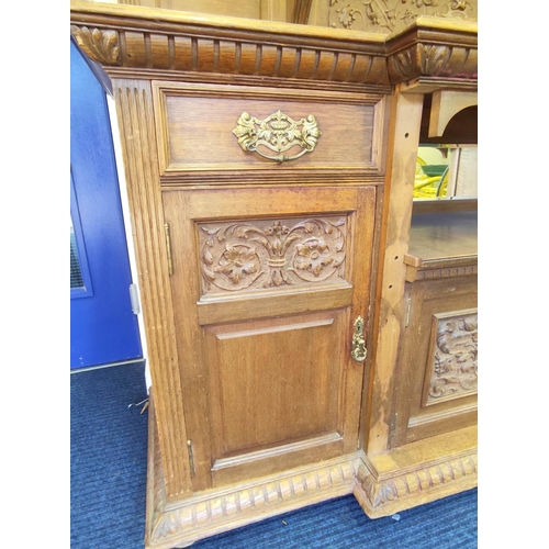 561 - Late 19th century light oak sideboard, the arched raised back with dentil cornice and foliate carved... 