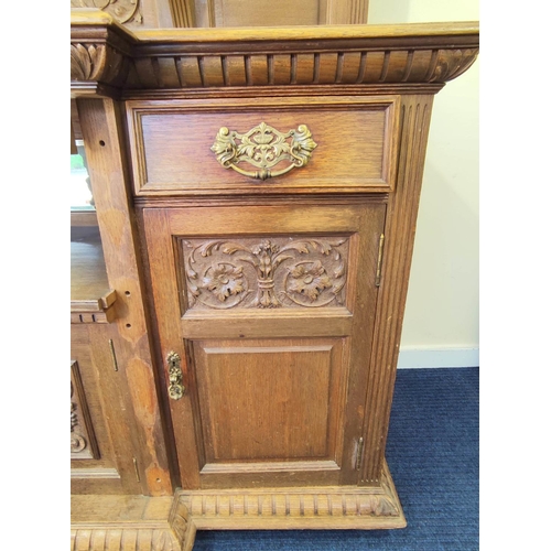 561 - Late 19th century light oak sideboard, the arched raised back with dentil cornice and foliate carved... 