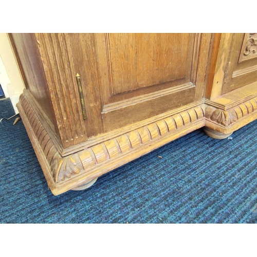 561 - Late 19th century light oak sideboard, the arched raised back with dentil cornice and foliate carved... 