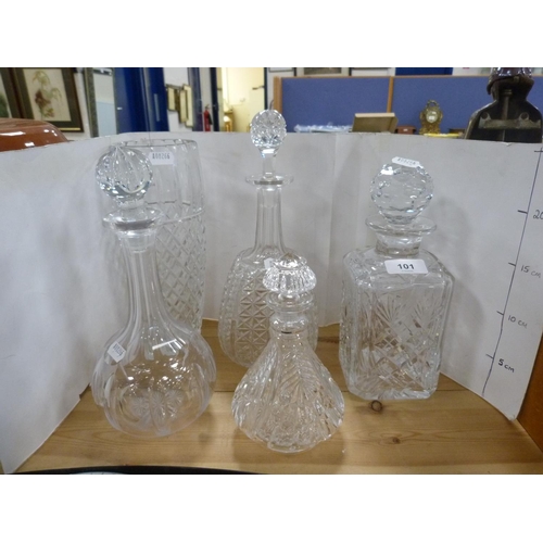 101 - Three assorted crystal and cut glass decanters with stoppers, cut glass vase and a smaller decanter ... 