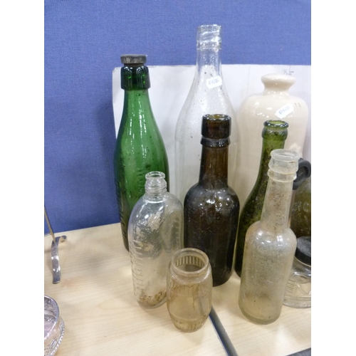 12A - Quantity of vintage bottles and a stone piggy bottle.