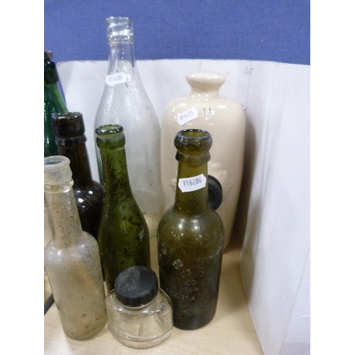 12A - Quantity of vintage bottles and a stone piggy bottle.
