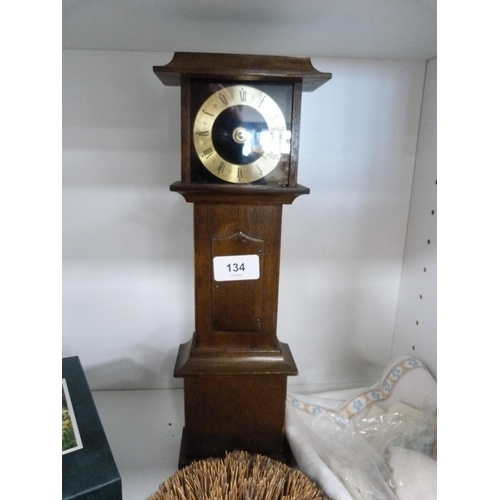 134 - Wall barometer, mantel clock modelled as a grandfather clock, hedgehog ornament, jigsaw puzzle, orna... 