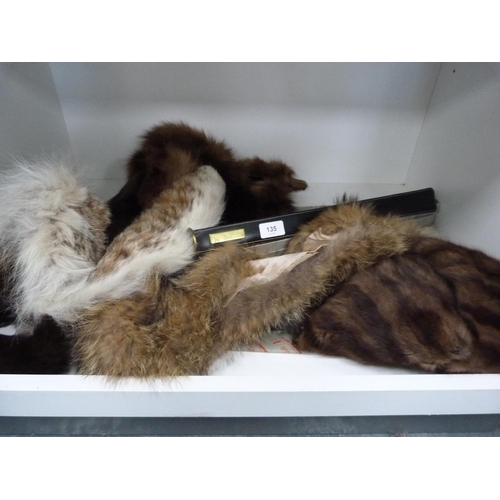 135 - Fur stoles, clothes brush (one shelf).