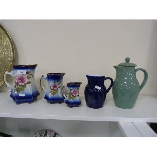 158 - Denby stoneware green glazed water jug and cover, blue glazed water jug and a set of three Staffords... 