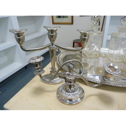 176 - EP oval serving tray, EP candle sconce, white metal candelabrum and two cut glass decanters with sto... 