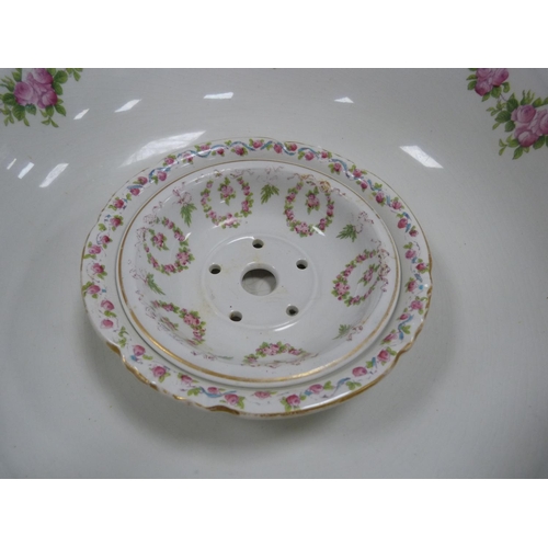 180 - Pottery toilet bowl decorated with garlands of pink roses, with a matching soap dish.