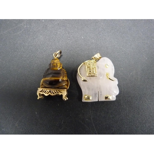 233 - 9ct gold-mounted pendant modelled as a Buddha and another pendant modelled as an elephant.