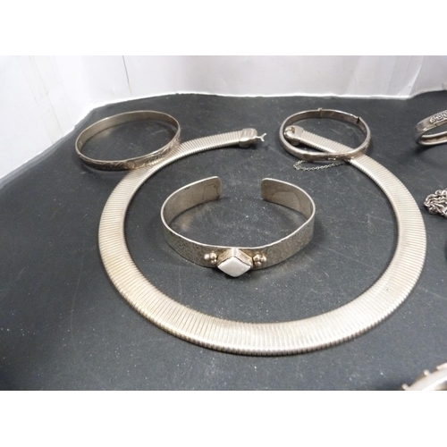 239 - Silver and other bangles, pendant and choker.