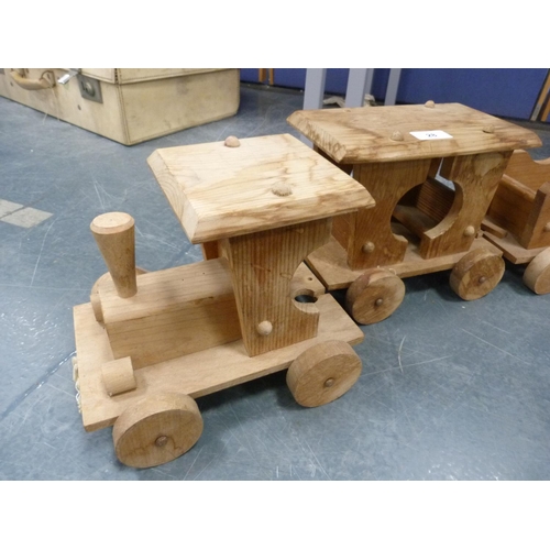28 - Wooden train comprising a locomotive, tender and two wagons.  (4)