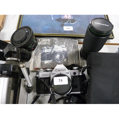 74 - Canon AE1 camera with manual, also a tripod, Hanimex lens and an Ozeck lens, Vivitar flash gun and a... 