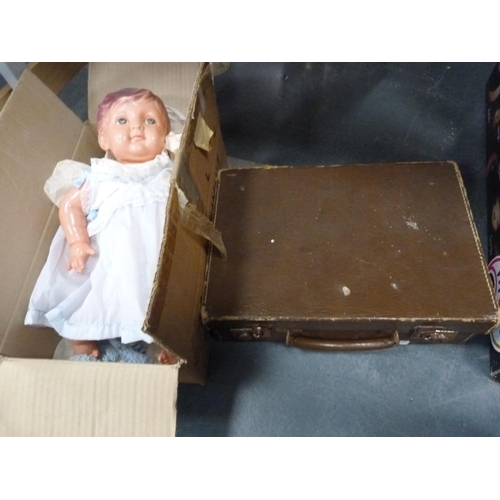 83 - Doll with clothing and a small suitcase.
