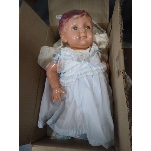 83 - Doll with clothing and a small suitcase.