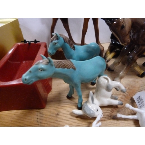 92 - Beswick foal and other horse ornaments, Wemyss-style pig ornaments, African-style ornaments, wooden ... 